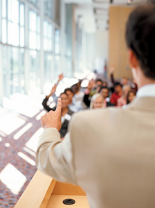 man in front of podium - Copyright – Stock Photo / Register Mark