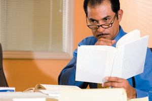 man reading book - Copyright – Stock Photo / Register Mark